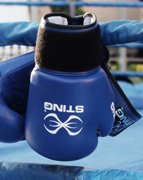 Guantoni da boxe appesi al ring